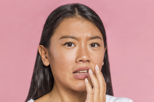 Woman covering her lip